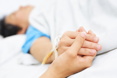 Holding patient hand in hospital